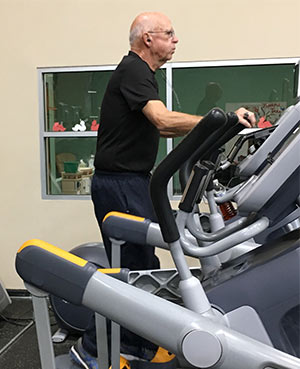 man on elliptical exercise machine